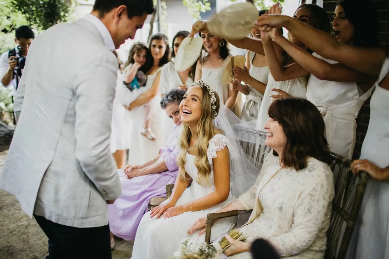 Tali & Jesse at Three Blue Ducks: Friends surround the smiling bride before the ceremony.