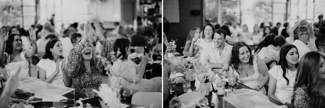 Tali & Jesse at Three Blue Ducks: Wedding guests watch the reception speeches, shown in black and white.