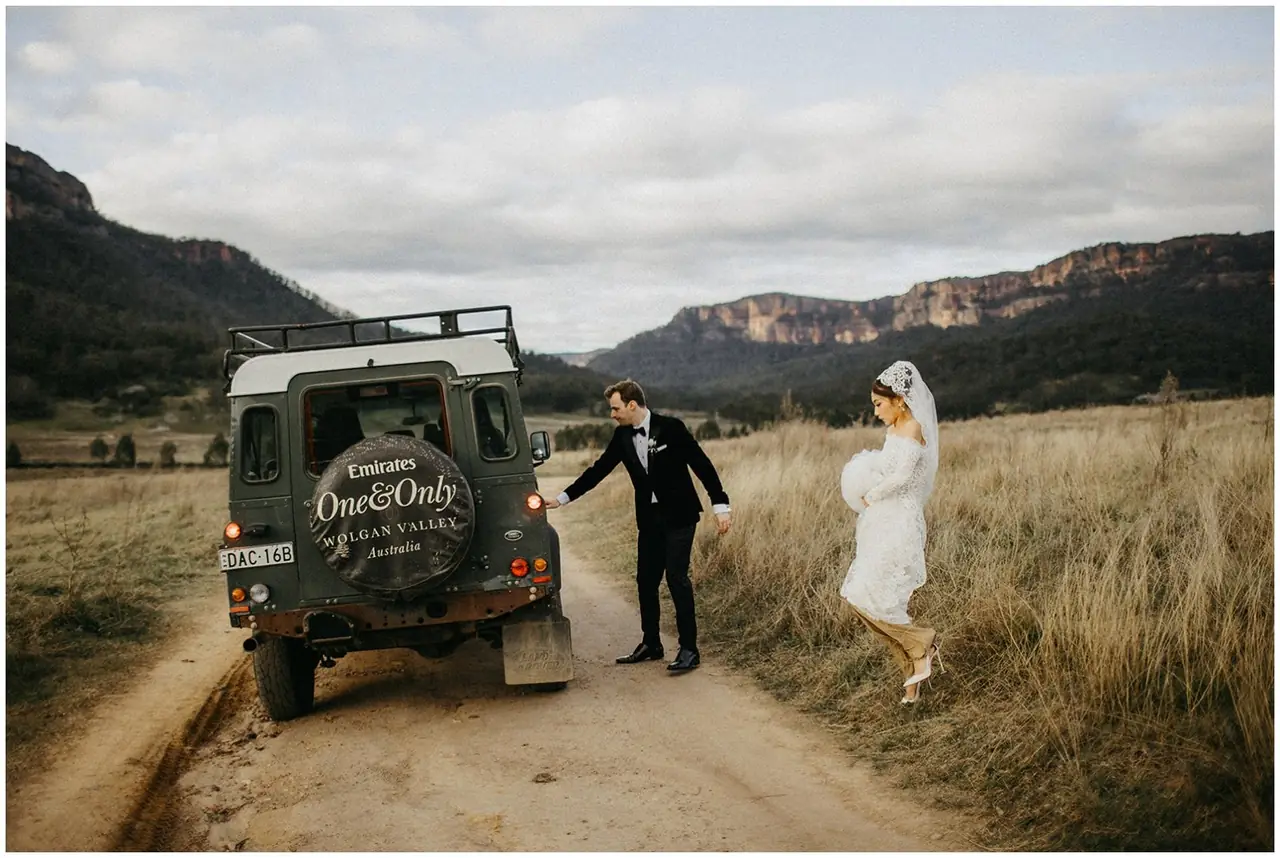 Tom & Josslyn at Emirates One&Only Wolgan Valley: The couple hold hands beside the vehicle on a country track.