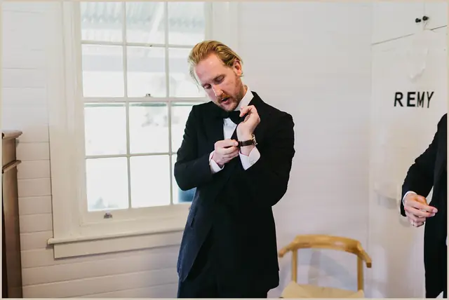Jess & Rich at The Orchard Estate: The groom adjusts his collar while getting ready.