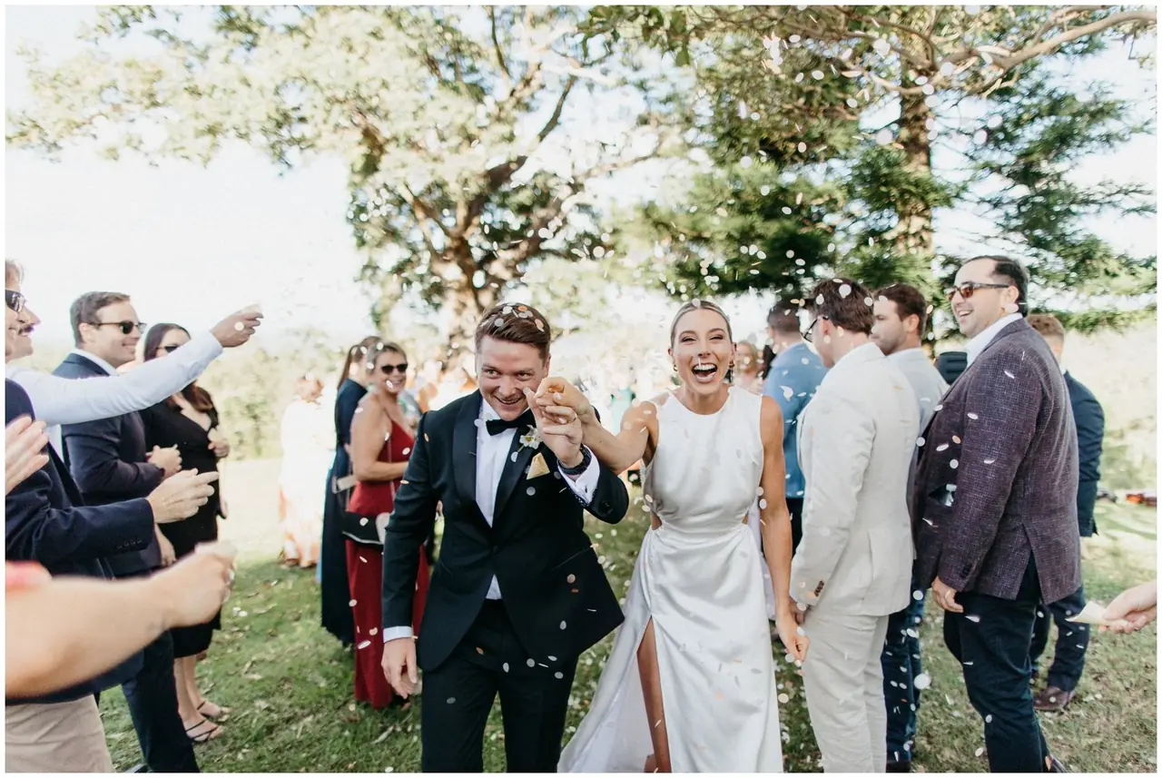 Ella & Jackson at The Woods: The newlyweds laugh as they walk through their cheering guests.