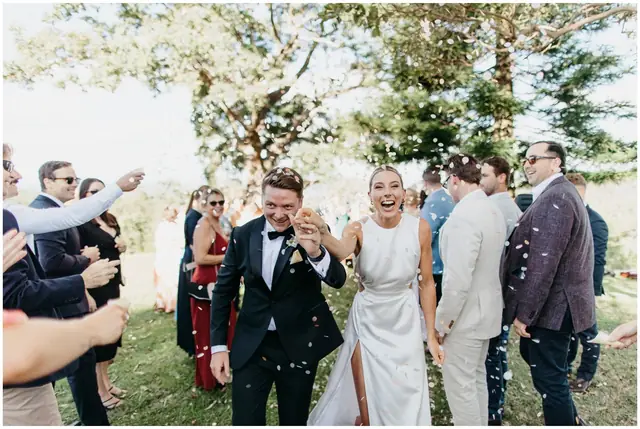 Ella & Jackson at The Woods: The newlyweds laugh as they walk through their cheering guests.