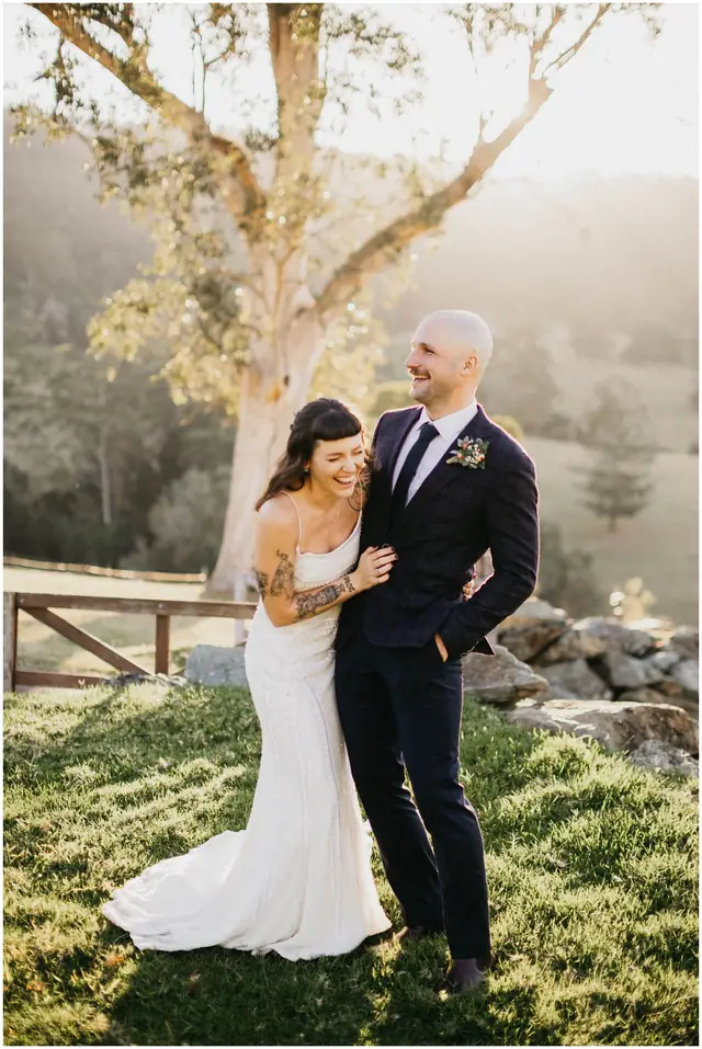 Luke & Cara at Cowbell Creek: A portrait of the couple beneath a sunlit tree.