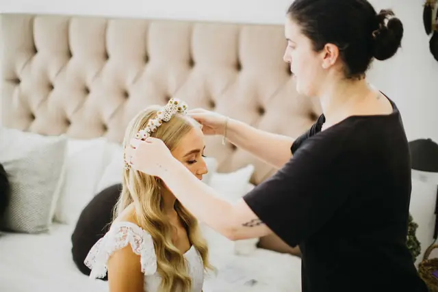 Tali & Jesse at Three Blue Ducks: The bride’s hair is adjusted as she gets ready.