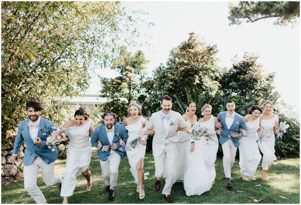 Marty & Nicola at Byron View Farm: The couple and their wedding party walk through the garden.
