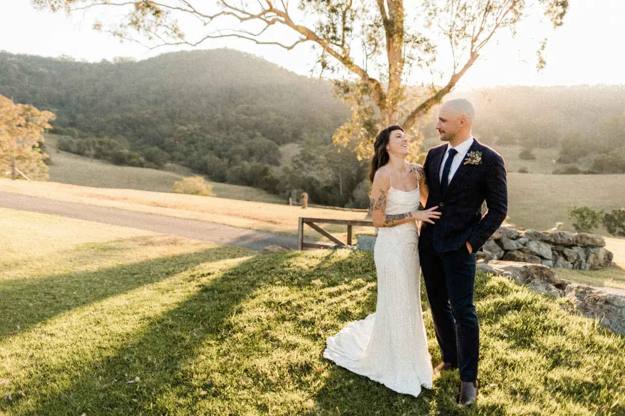 Luke & Cara at Cowbell Creek: The couple stand beneath a tree in the evening light.