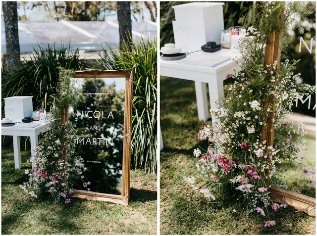 Marty & Nicola at Byron View Farm: Wedding welcome sign and floral arrangements beside an outdoor table.