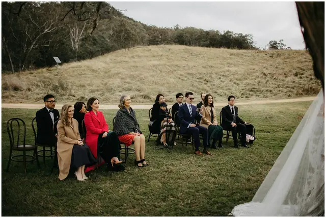 Tom & Josslyn at Emirates One&Only Wolgan Valley: A small group of wedding guests sit facing the ceremony.