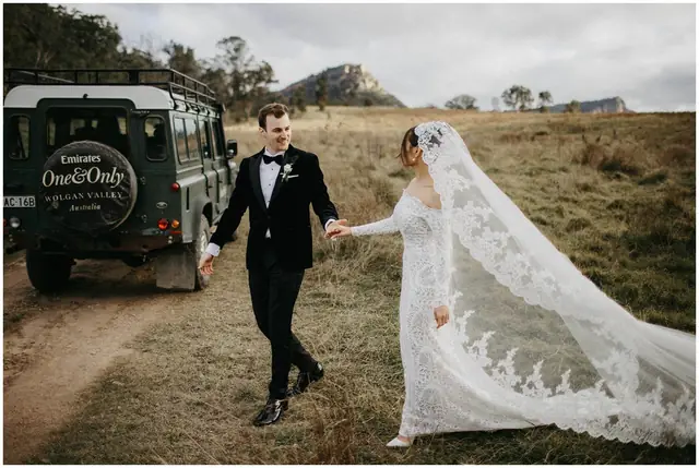 Tom & Josslyn at Emirates One&Only Wolgan Valley: The couple walk hand in hand beside the four-wheel drive.