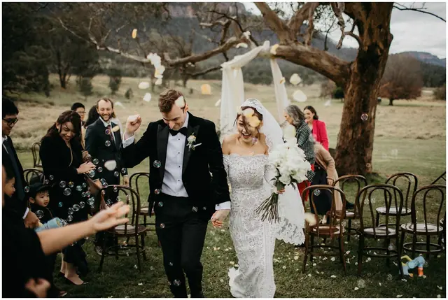 Tom & Josslyn at Emirates One&Only Wolgan Valley: Guests celebrate as the newlyweds walk out from their ceremony.