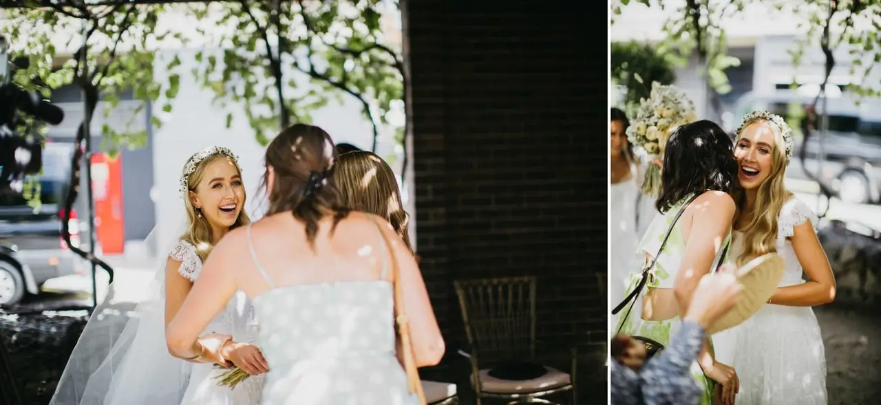 Tali & Jesse at Three Blue Ducks: The bride shares embraces with friends outside.