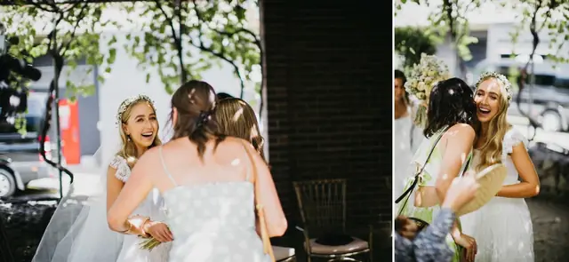 Tali & Jesse at Three Blue Ducks: The bride shares embraces with friends outside.