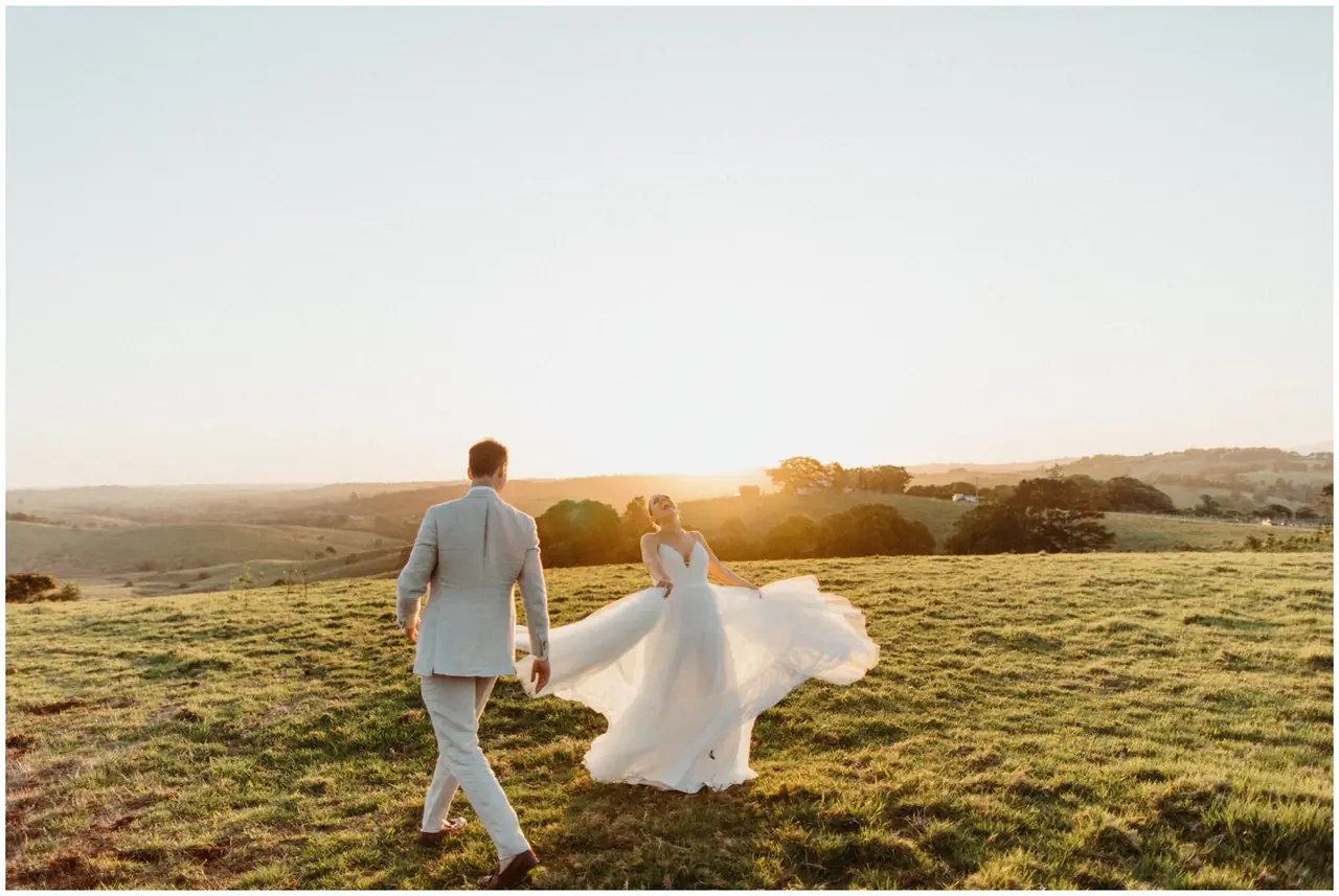 Marty & Nicola at Byron View Farm: The couple walk through a paddock in the evening light.
